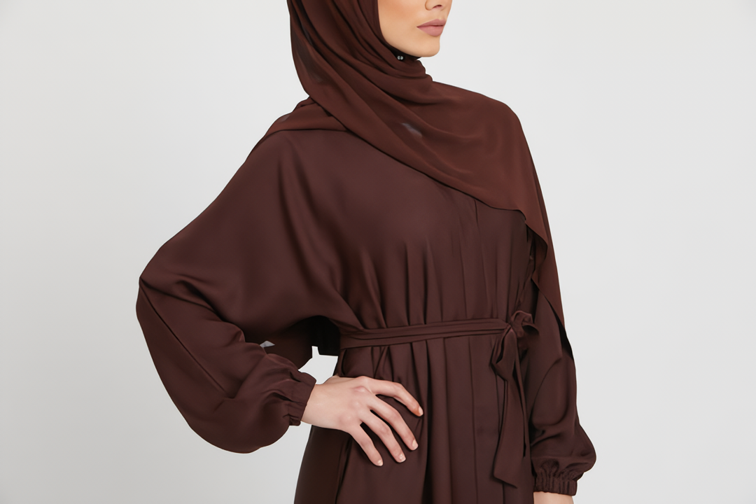 Close-up zoom of chest design on brown kimono abaya with white inner slip dress, elegant modest abaya fashion for women