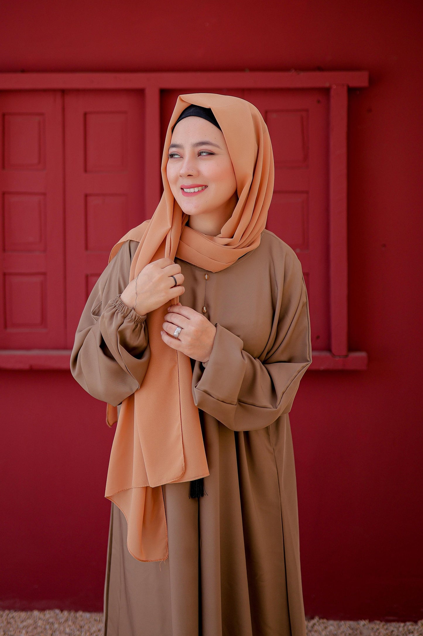 Close-up view showing fabric texture and elastic cuffs of light brown abaya