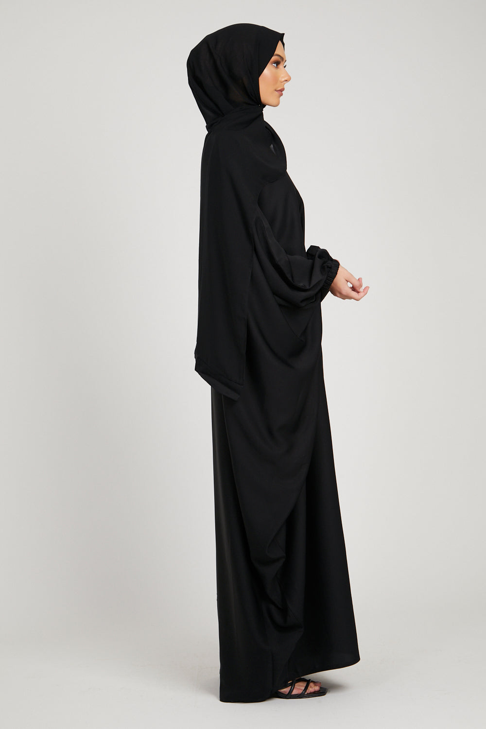 Side full view of black kaftan abaya with cuff detailing, elegant modest wear abaya for women in Pakistan