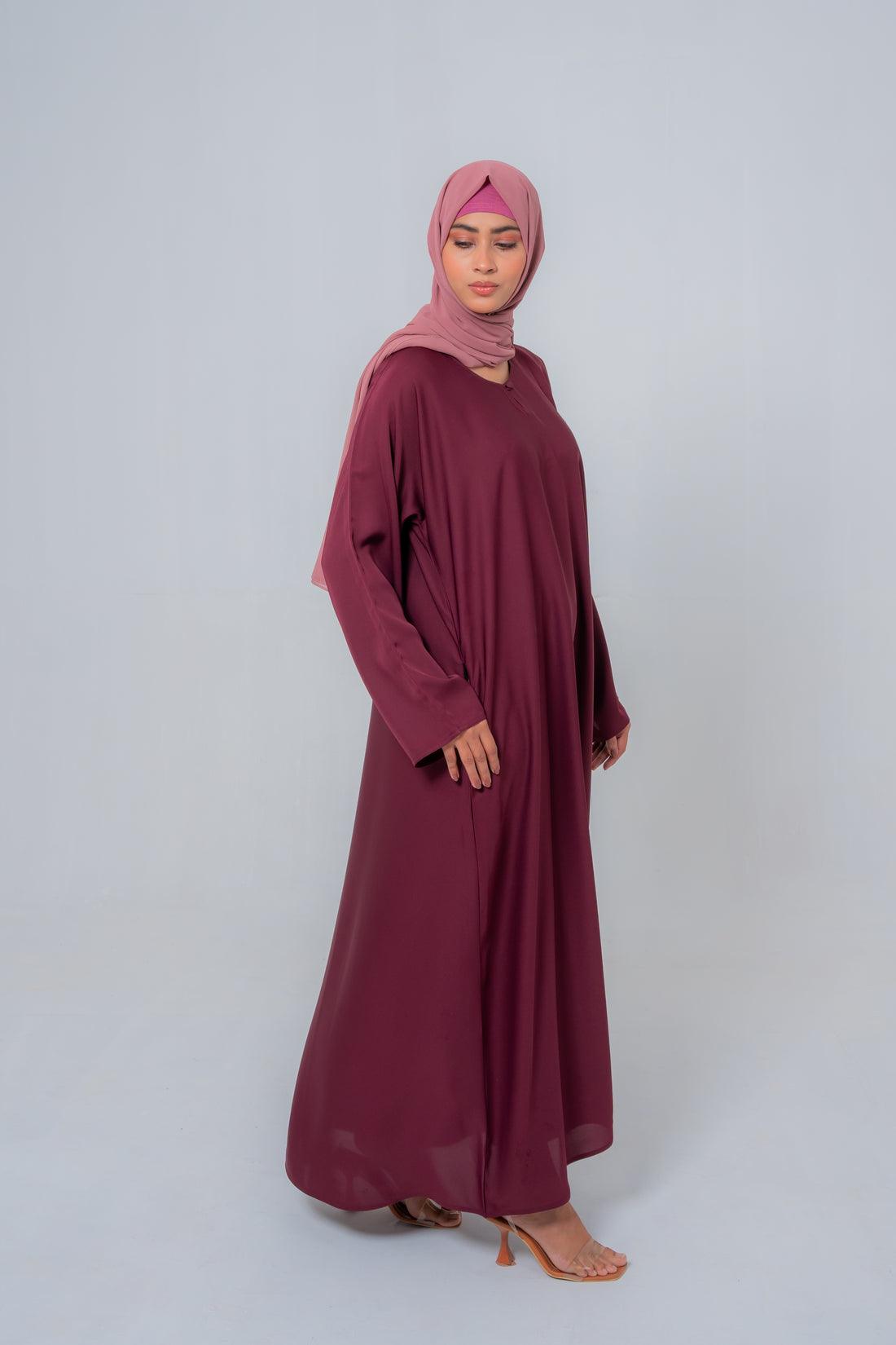 Side angle of The Basic Simple Maroon Abaya highlighting flowy silhouette, premium fabric, and modest women’s fashion style