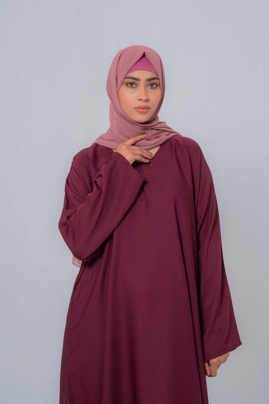 Zoom-in close-up of The Basic Simple Maroon Abaya front highlighting premium nida fabric texture, stitching details, and elegant modest design for women