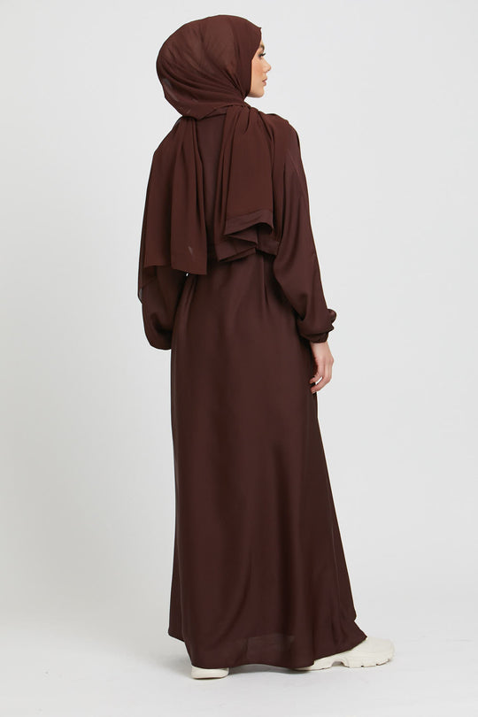 Back side full view of brown kimono abaya layered with white slip dress, stylish modest abaya for women