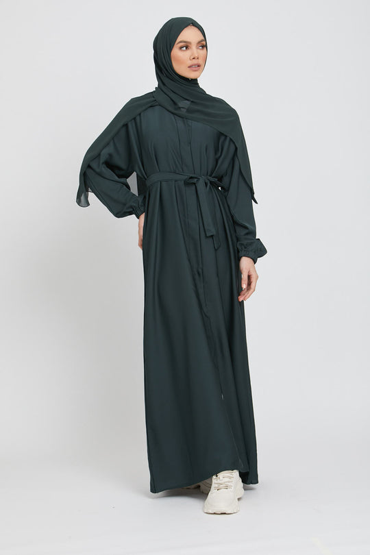 Full front view of green kimono abaya layered with white slip dress, stylish modest abaya outfit for women