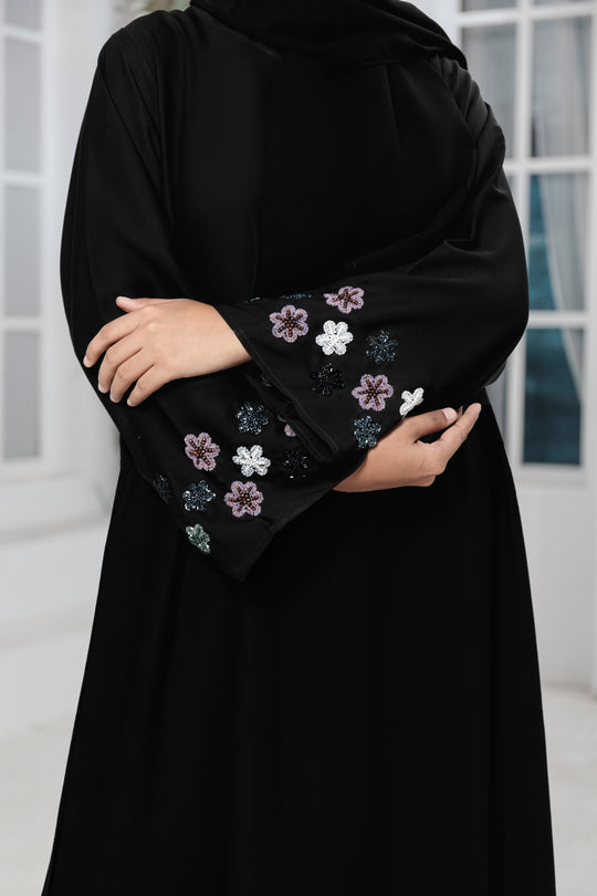 Close-up front zoom of hand-work embroidery on sleeves of luxury abaya made with imported Nida fabric