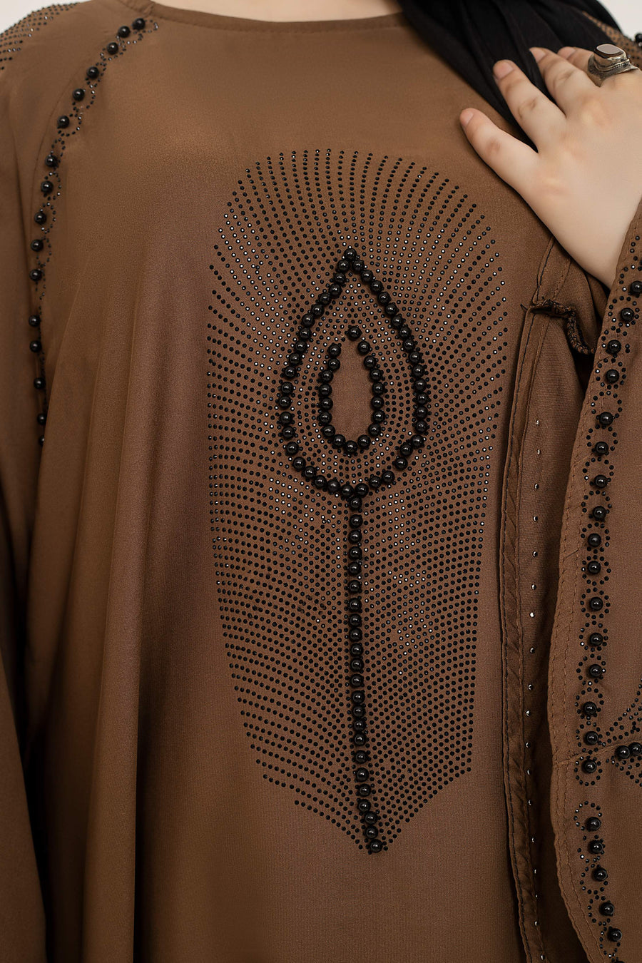 Detailed close-up of nug and moti work embellishment on abaya chest area, elegant modest wear abaya for women in Pakistan