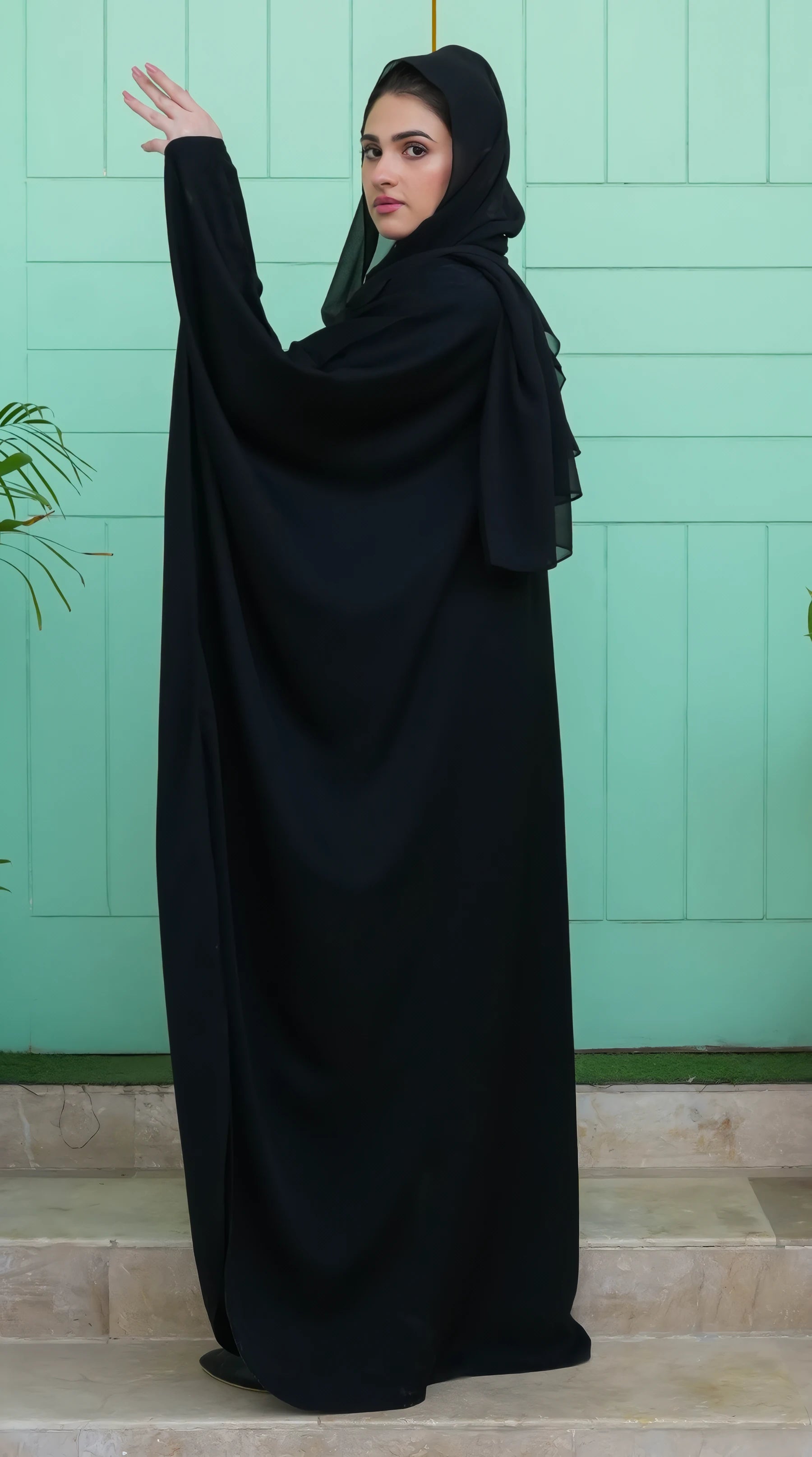 Side profile of Black Premium Kaftan for Women – highlighting relaxed silhouette and premium Nida texture for a refined look.